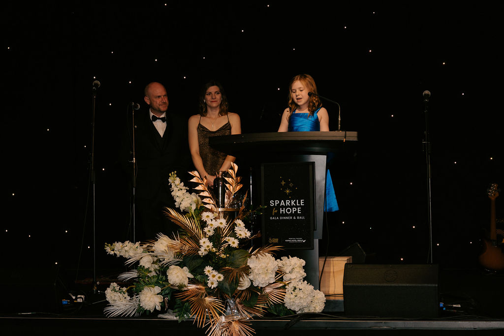 Indi on stage at Sparkle for Hope 2025